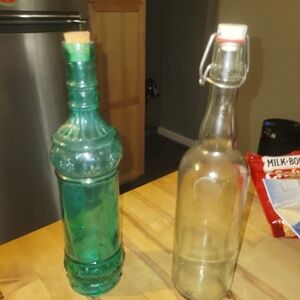 Two different unique bottles both with closures.